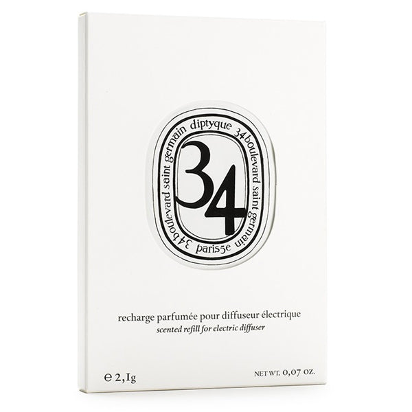 Diptyque - 34 Boulevard Saint Germain - Capsule in schlichter weißer Verpackung mit elegantem ovalem Logo und klarer Typografie