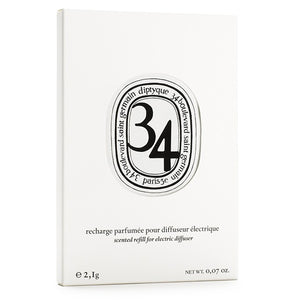 Diptyque - 34 Boulevard Saint Germain - Capsule in schlichter weißer Verpackung mit elegantem ovalem Logo und klarer Typografie