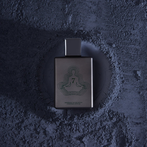 Spiritum - 7 - Spiritual Explorer Parfumflakon in dunklem Design mit meditativem Motiv auf rauem dunklem Untergrund