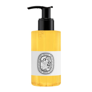 Diptyque - Do Son - Cleansing Body Oil in goldgelber Flasche mit schwarzem Pumpspender vor weißem Hintergrund