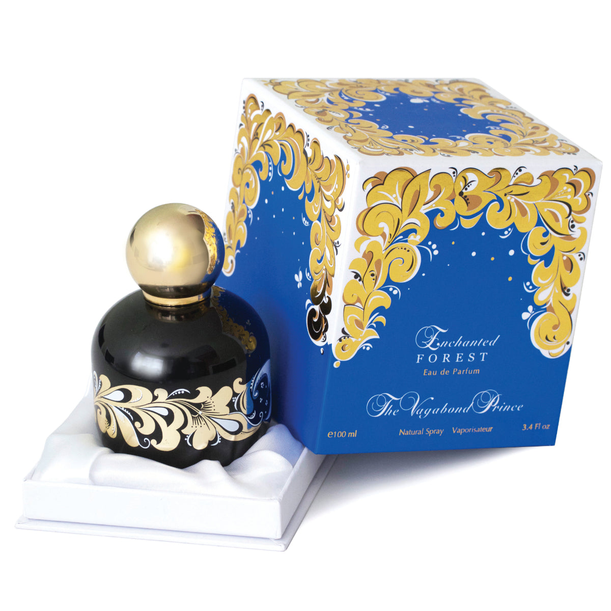 The Vagabond Prince - Enchanted Forest zeigt schwarzen Flakon mit goldfarbenem Ornament vor blau-weiß-goldener Verpackung
