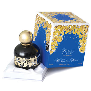 The Vagabond Prince - Enchanted Forest zeigt schwarzen Flakon mit goldfarbenem Ornament vor blau-weiß-goldener Verpackung
