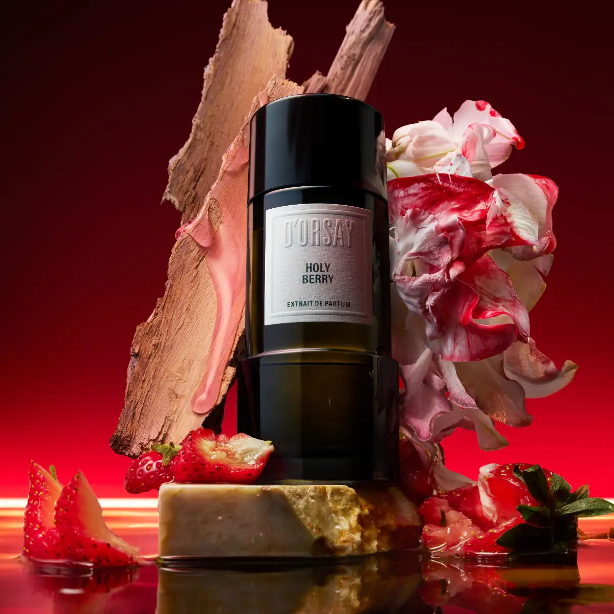 D’Orsay - Holy Berry Extrait de Parfum auf Marmor mit fruchtigen Beeren und Holz vor rotem Hintergrund