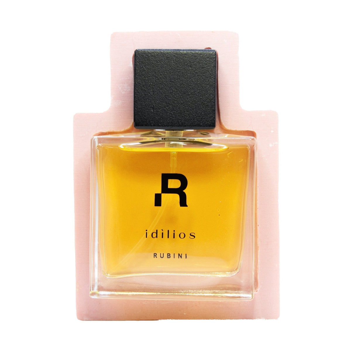 Rubini - Idìlios Parfumflakon mit klarem Glas und schwarzem rechteckigem Verschluss vor rosa Hintergrund
