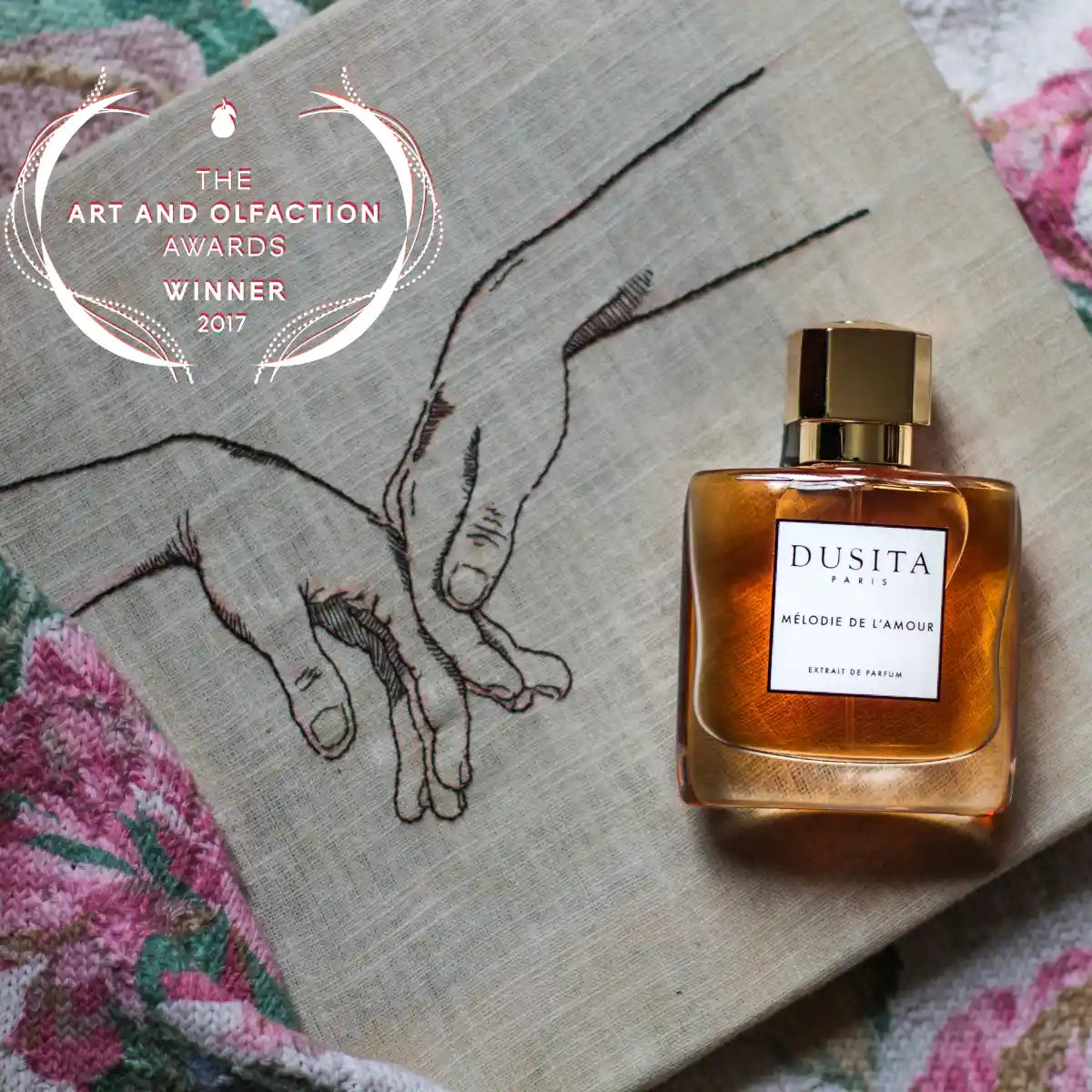 Dusita - Mélodie de l’Amour Parfumflakon mit goldenem Verschluss auf besticktem Stoff mit Handmotiv und floralem Muster