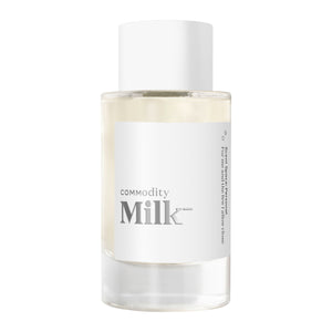 Commodity - Milk- Parfumflakon mit minimalistischem weißen Etikett und klarem Design vor hellem Hintergrund
