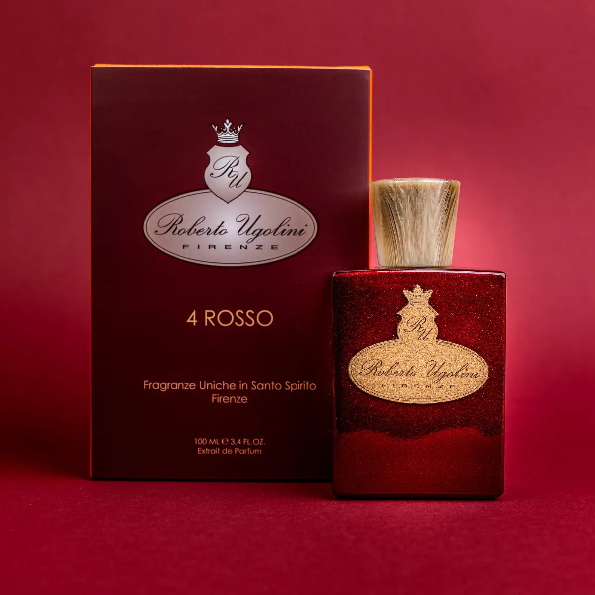 Roberto Ugolini - 4 Rosso roter Parfumflakon mit goldfarbenem Emblem neben edler Geschenkbox vor rotem Hintergrund
