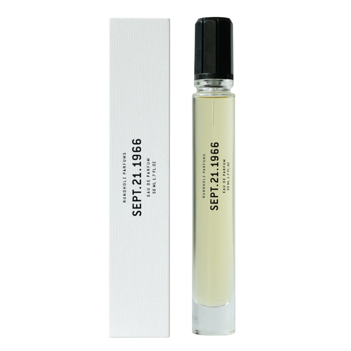 Rundholz Parfums - SEPT.21.1966 schlanker Glasflakon mit hellem Parfüm und schwarzem Verschluss neben weißer Verpackung