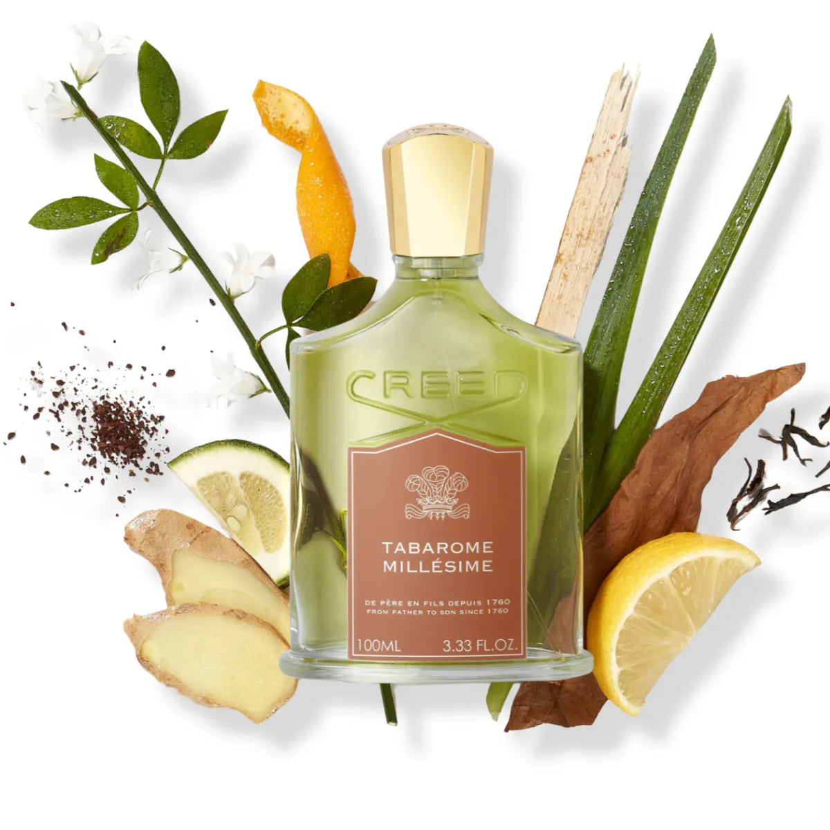 Creed - Tabarome Millesime Parfumflakon mit goldfarbenem Verschluss umgeben von natürlichen Duftnoten auf weißem Hintergrund