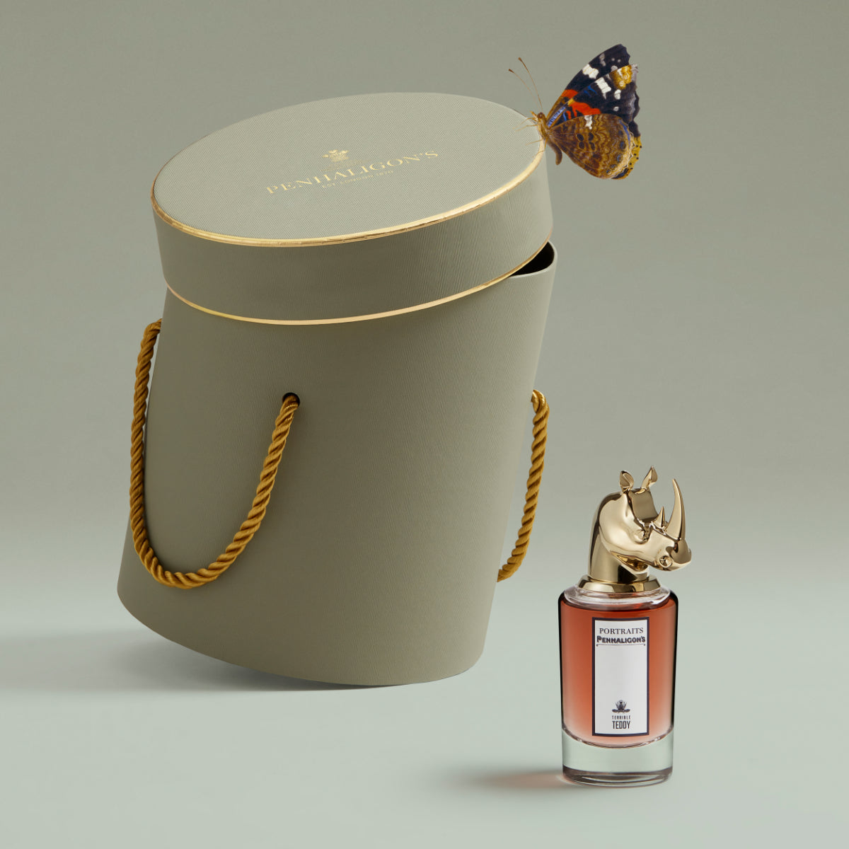 Penhaligon's - Portraits - Terrible Teddy elegant verpackter Duft mit goldfarbenem Nashornverschluss und Schmetterling auf Dose