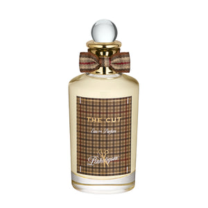 Penhaligon's - British Tales - The Cut Parfumflakon mit Schottenmuster und eleganter Schleife vor weißem Hintergrund