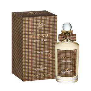 Penhaligon's - British Tales - The Cut Parfumflakon mit kariertem Muster und eleganter Schleife vor weißem Hintergrund