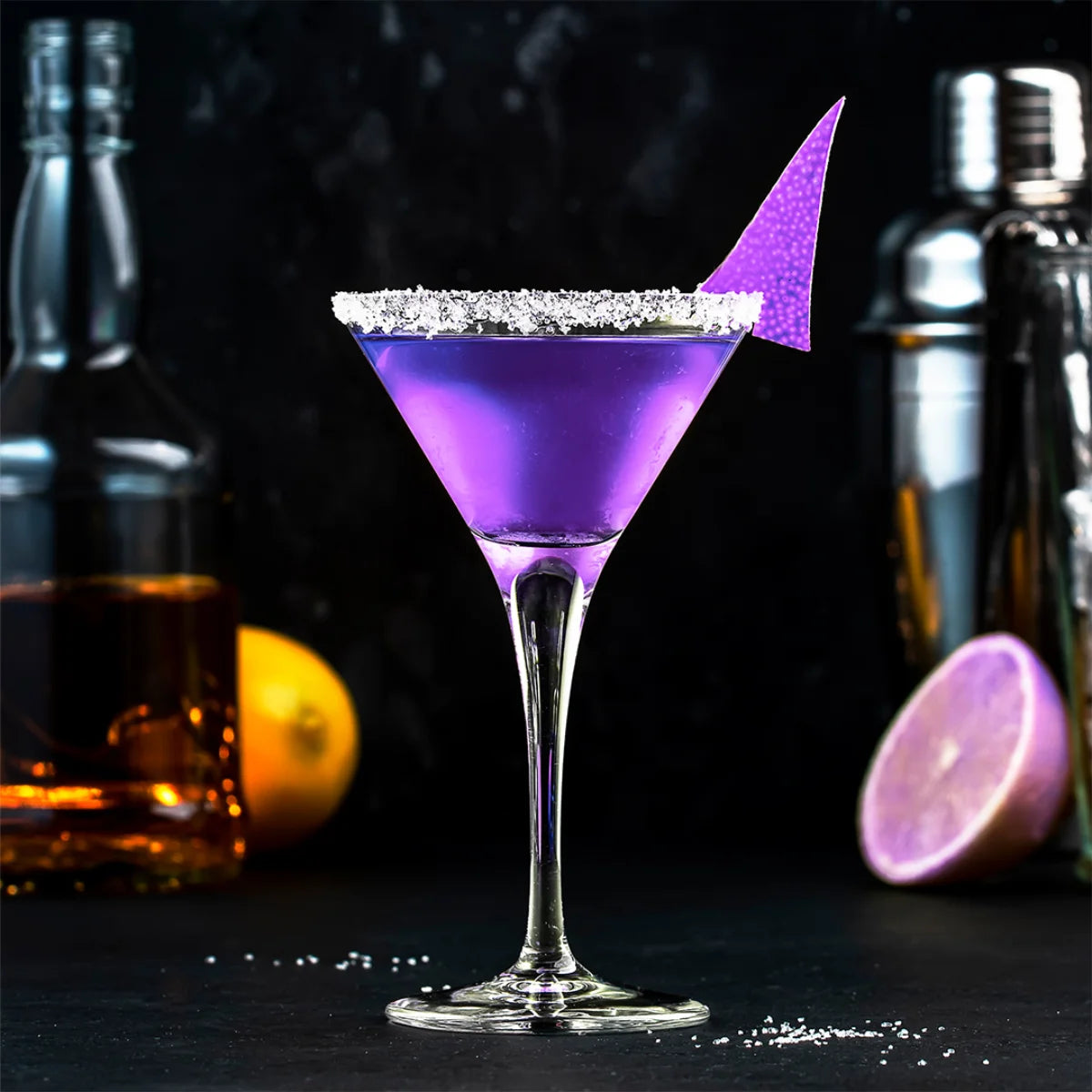 Cherigan - The Purple Bar Cocktail mit violettem Getränk und gezuckertem Glasrand vor dunklem Hintergrund
