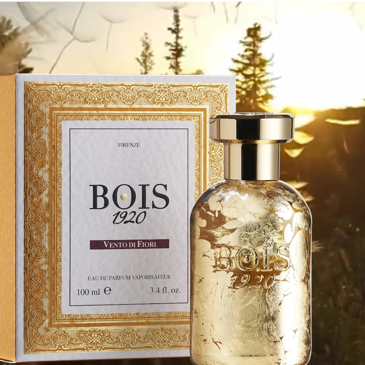 Bois 1920 - Vento di Fiori edler Parfumflakon mit goldener Verzierung und dazugehöriger dekorativer Verpackung vor natürlichem Hintergrund