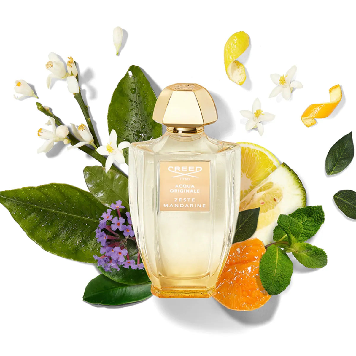 Creed - Acqua Originale - Zeste Mandarine mit goldenem Verschluss umgeben von Zitronenblättern und Blüten