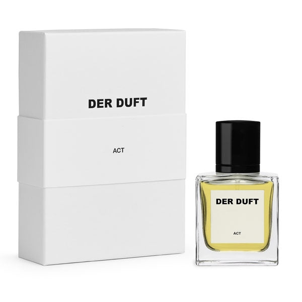 DER DUFT - Act Parfumflakon mit klarem Glas, gelber Flüssigkeit und schwarzem Verschluss neben weißer Verpackung