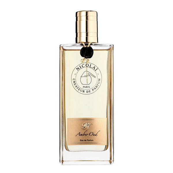 Nicolaï - Amber Oud Parfumflakon mit klarem Glas, goldfarbenem Verschluss und elegantem, minimalistischem Design