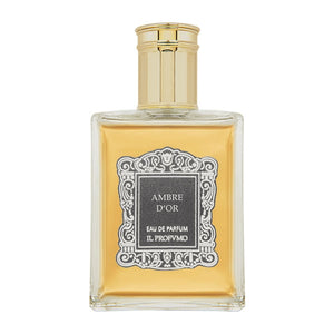 Il Profumo - Ambre d'Or Parfumflakon mit bernsteinfarbenem Inhalt und goldenem Verschluss vor weißem Hintergrund
