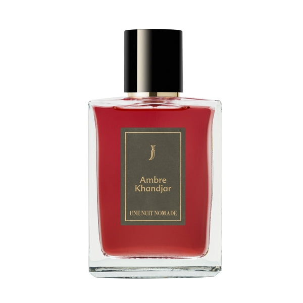 Une Nuit Nomade - Une Nuit a Oman - Ambre Khandjar Parfumflakon mit tiefrotem Inhalt und schwarzer Kappe vor weißem Hintergrund