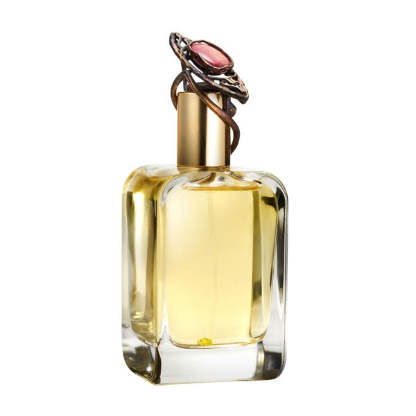 Mendittorosa - Amygdala Parfumflakon mit goldfarbenem Verschluss und rosa Schmuckstein auf weißem Hintergrund