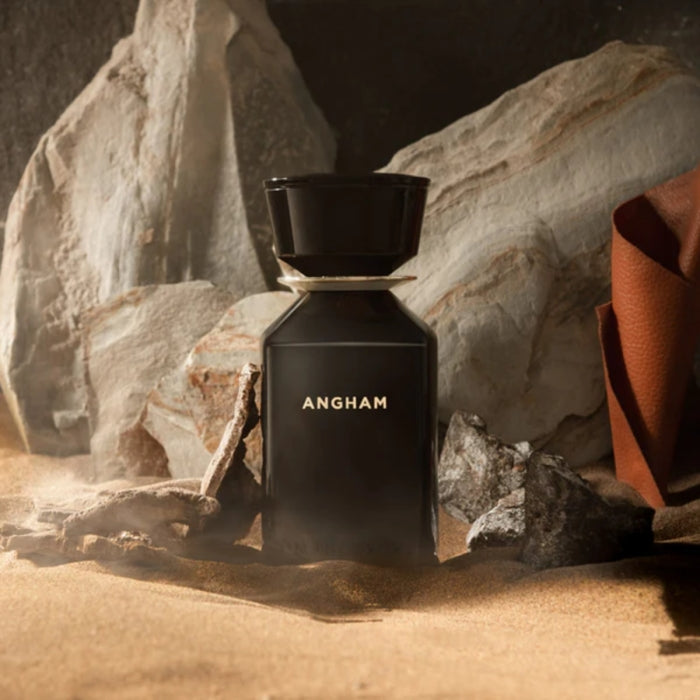 Omanluxury - Angham - Limited Collection Parfümflakon in tiefschwarzem Design auf sandigem felsigen Hintergrund
