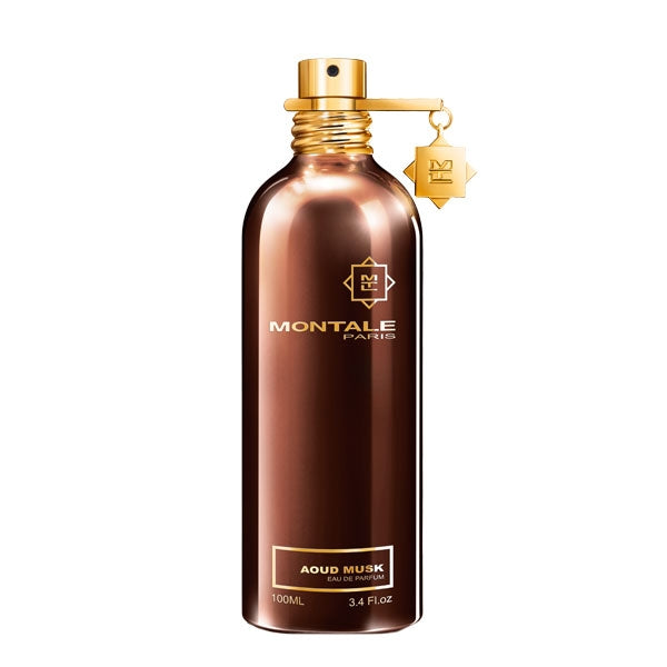 Montale - Aoud Musk glänzender brauner Flakon mit goldfarbenem Verschluss und zartem Anhänger vor weißem Hintergrund