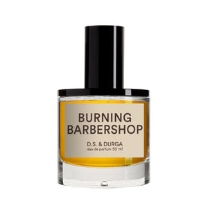 D.S. & Durga - Burning Barbershop Parfümflakon mit schwarzem Verschluss und orangefarbenem Inhalt vor weißem Hintergrund