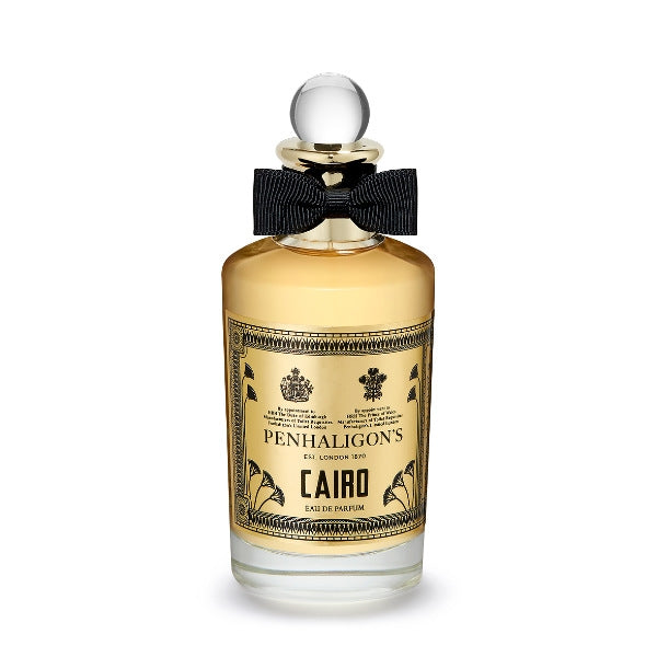 Penhaligon's - Trade Routes - Cairo Parfumflakon mit goldfarbenem Etikett und schwarzer Schleife vor weißem Hintergrund