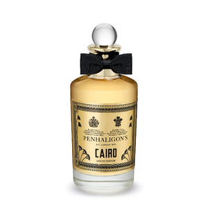 Penhaligon's - Trade Routes - Cairo Parfumflakon mit goldfarbenem Etikett und schwarzer Schleife vor weißem Hintergrund