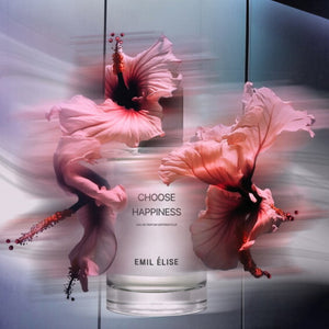 Emil Élise - choose happiness Parfumflakon mit lebendigem Hibiskusmotiv und zartem Farbspiel vor hellem Hintergrund