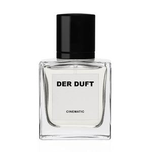 DER DUFT - Cinematic Parfumflakon mit klarem Glas, schwarzem Verschluss und schlichter weißer Etikettgestaltung vor weißem Hintergrund