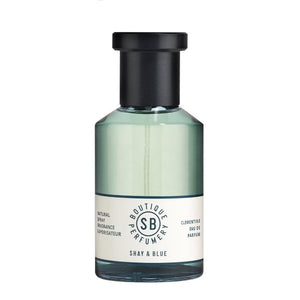 Shay & Blue - Clementine Parfumflakon mit grünlichem Inhalt und schlichtem Etikett vor weißem Hintergrund