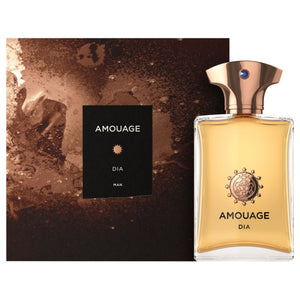 Amouage Dia Man men's fragrance in clear bottle with golden cap beside textured brown and black packaging on white background