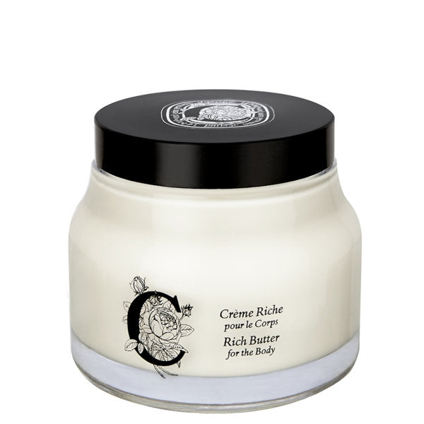 Diptyque - Rich Butter for the Body in rundem Glas mit schwarzem Deckel und elegantem floralem Design vor weißem Hintergrund