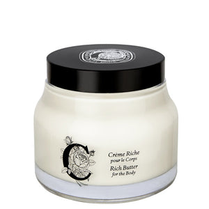 Diptyque - Rich Butter for the Body in rundem Glas mit schwarzem Deckel und elegantem floralem Design vor weißem Hintergrund