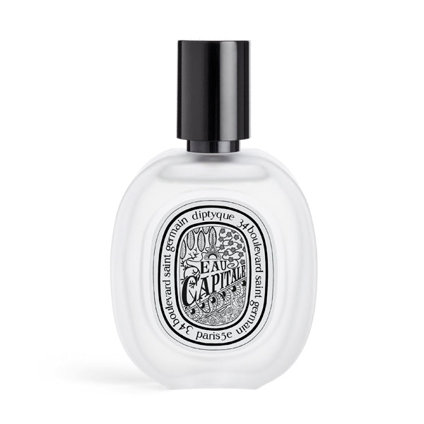 Diptyque - Eau Capitale - Hair Mist zarter, klarer Flakon mit schwarzem Sprühkopf vor hellem Hintergrund