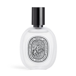 Diptyque - Eau Capitale - Hair Mist zarter, klarer Flakon mit schwarzem Sprühkopf vor hellem Hintergrund
