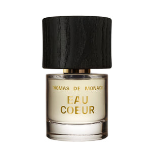 Thomas de Monaco - Eau Coeur Parfumflakon mit goldener Schrift und schwarzem Holzdeckel auf weißem Hintergrund