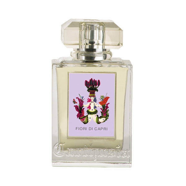 Carthusia - Fiori di Capri Parfumflakon mit klarem Glas und kunstvollem floralen Emblem auf zart lilafarbenem Hintergrund