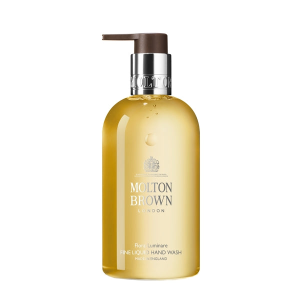 Molton Brown - Flora Luminare - Fine Liquid Hand Wash in transparenter Flasche mit braunem Pumpspender vor weißem Hintergrund