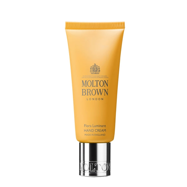 Molton Brown - Flora Luminare Hand Cream in gelber Tube mit silbernem Verschluss vor weißem Hintergrund