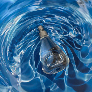 Nomenclature - fluo_ral Parfumflakon in tropfenförmigem Glas mit bläulichem Wasserreflexionseffekt