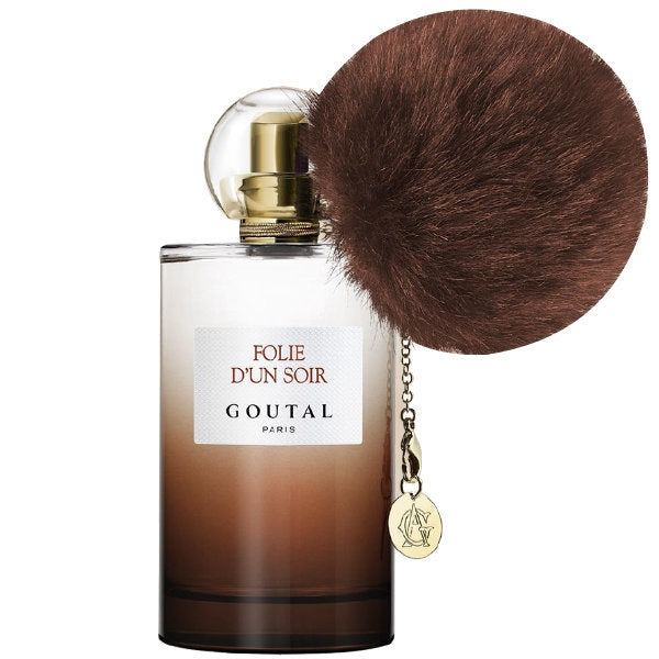 Goutal - Folie d'un Soir Parfumflakon mit braunem Farbverlauf und flauschigem Anhänger am goldenen Verschluss