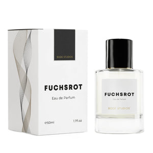 Bodé Studios - Fuchsrot Parfumflakon und elegante Verpackung mit minimalistischem Design vor weißem Hintergrund