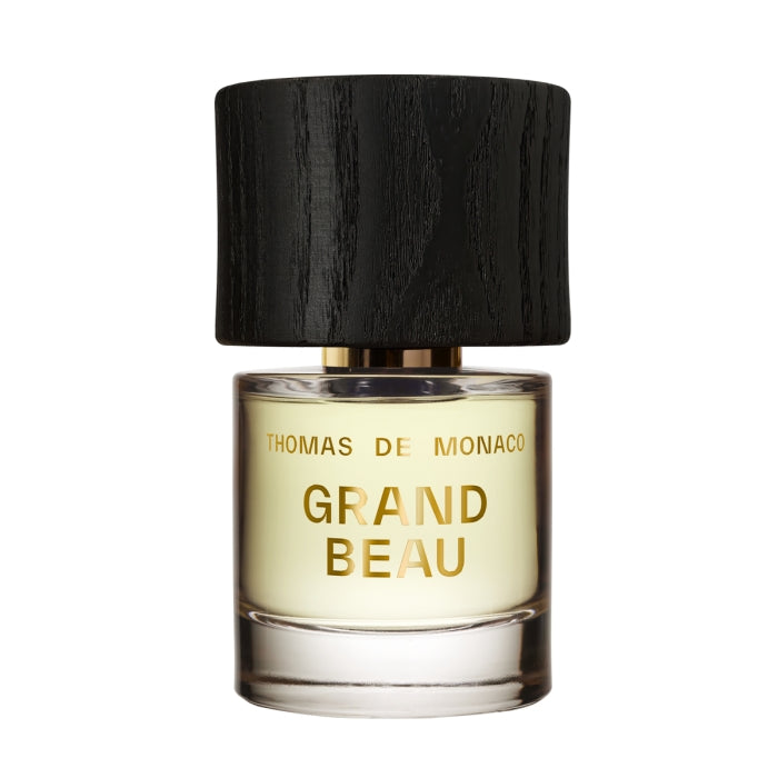 Thomas de Monaco - Grand Beau Parfumflakon mit schwarzem Holzdeckel und goldener Schrift auf klarem Glas vor weißem Hintergrund