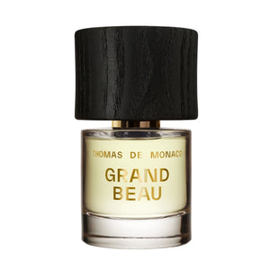 Thomas de Monaco - Grand Beau Parfumflakon mit schwarzem Holzdeckel und goldener Schrift auf klarem Glas vor weißem Hintergrund