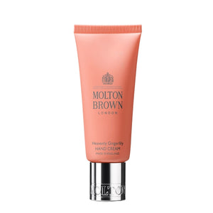 Molton Brown - Heavenly Gingerlily Hand Cream in orangefarbener Tube mit silbernem Verschluss auf weißem Hintergrund