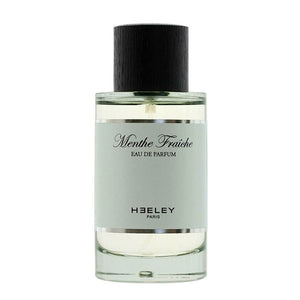 Heeley - Menthe Fraîche Parfumflakon mit hellem Duft und schwarzem Holzverschluss vor weißem Hintergrund