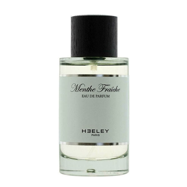 Heeley - Menthe Fraîche Parfumflakon mit hellem Duft und schwarzem Holzverschluss vor weißem Hintergrund