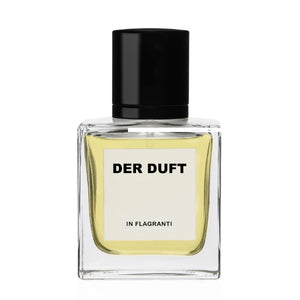 DER DUFT - In Flagranti Parfumflakon mit klarer Glasflasche und schwarzem Verschluss vor weißem Hintergrund